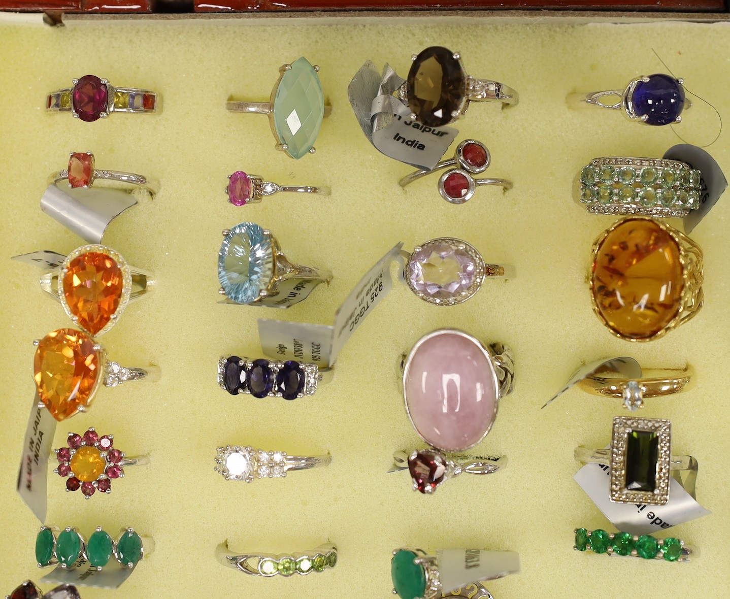 Forty seven assorted modern 925 and gem set rings and seven assorted modern 9ct gold and gem set rings, in ring box (hinges damaged).
